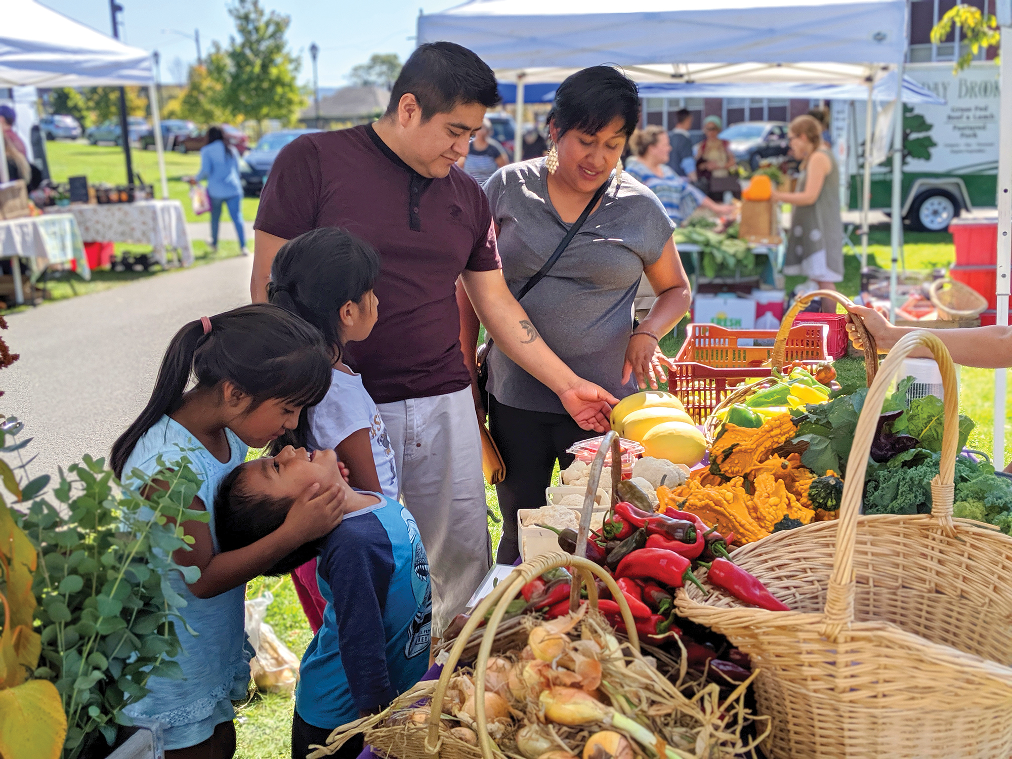 Family buying vegetables at Pittsfield farmer's market